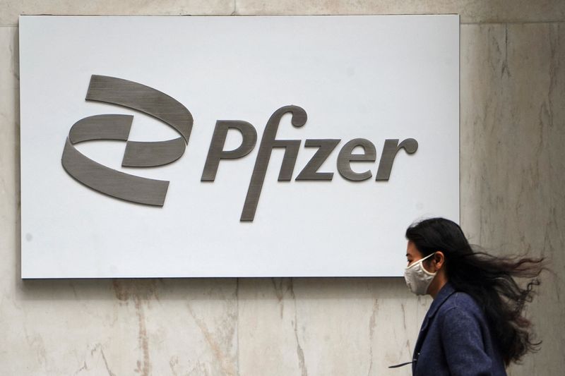 &copy; Reuters. FILE PHOTO: A person walks past a Pfizer logo in the Manhattan borough of New York City, New York, U.S., April 1, 2021. REUTERS/Carlo Allegri