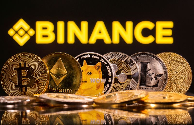 © Reuters. FILE PHOTO: Representations of cryptocurrencies Bitcoin, Ethereum, DogeCoin, Ripple, and Litecoin are seen in front of a displayed Binance logo in this illustration taken, June 28, 2021. REUTERS/Dado Ruvic/Illustration/File Photo