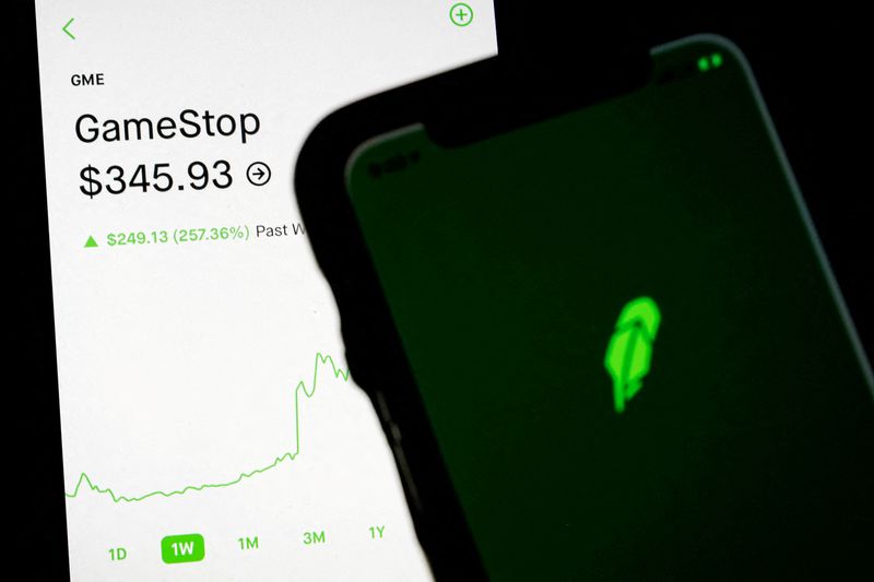 &copy; Reuters. FILE PHOTO: Trading information for GameStop is displayed on the Robinhood App as another screen displays the Robinhood logo in this photo illustration January 29, 2021. REUTERS/Brendan McDermid/Illustration/File Photo