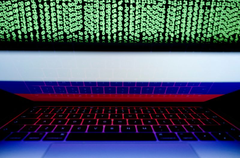 © Reuters. FILE PHOTO: A Russian flag is seen on the laptop screen in front of a computer screen on which cyber code is displayed, in this illustration picture taken March 2, 2018. REUTERS/Kacper Pempel/Illustration