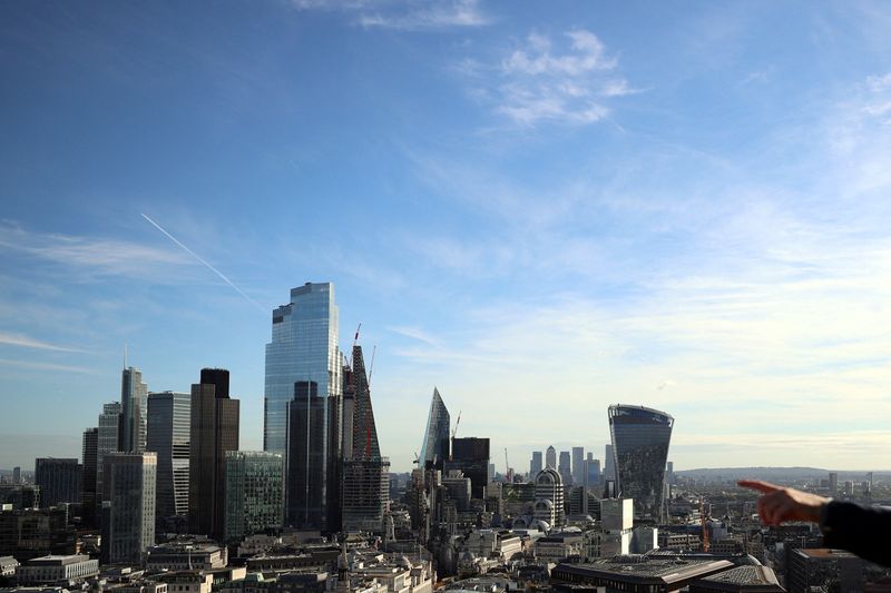 &copy; Reuters. FILE PHOTO: A person points to the City of London financial district from a viewing platform in London, Britain, October 22, 2021. REUTERS/Hannah McKay