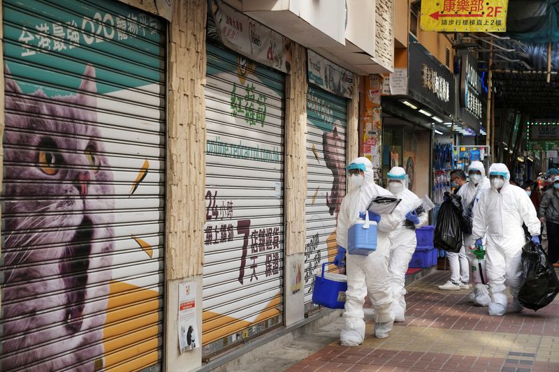 &copy; Reuters. FILE PHOTO: Officers in protective suits walk outside a closed pet shop in Mong Kok district after a hamster cull was ordered to curb the coronavirus disease (COVID-19) outbreak, in Hong Kong, China, January 19, 2022. REUTERS/Lam Yik