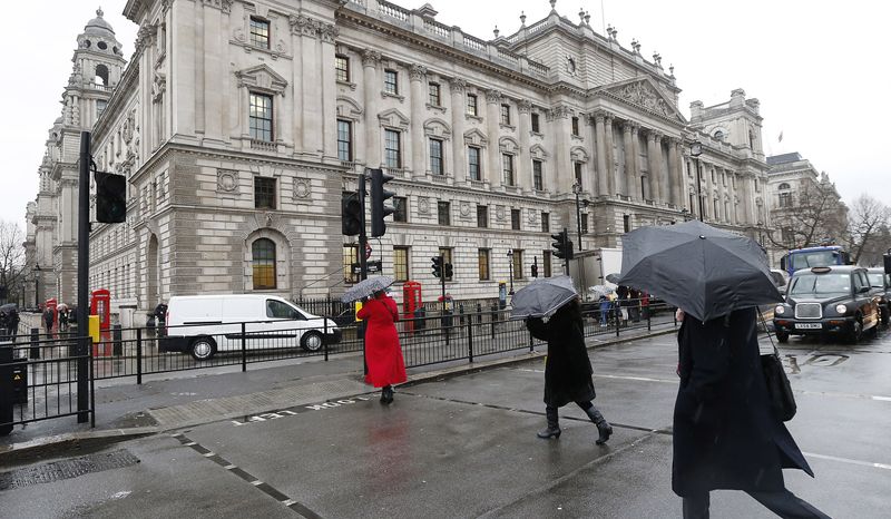 &copy; Reuters. FILE PHOTO: Pedestrians walk past the HM Revenue & Customs building in Whitehall, central London December 14, 2012. REUTERS/Suzanne Plunkett 