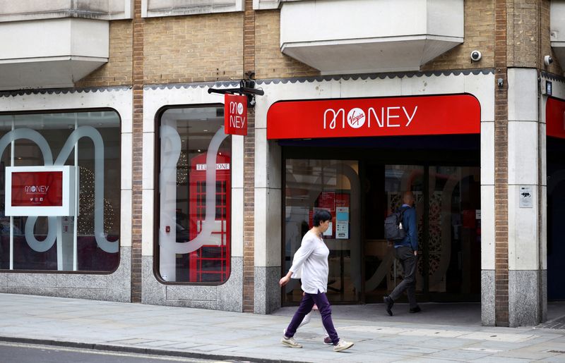 &copy; Reuters. FILE PHOTO: People walk past a Virgin Money store in central London, Britain, July 27, 2021. REUTERS/Henry Nicholls