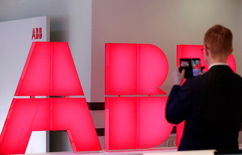 &copy; Reuters. FILE PHOTO: A man takes pictures of the logo of Swiss power technology and automation group ABB ahead of a news conference to present the company's full year results, in Zurich, Switzerland, February 8, 2018. REUTERS/Moritz Hager