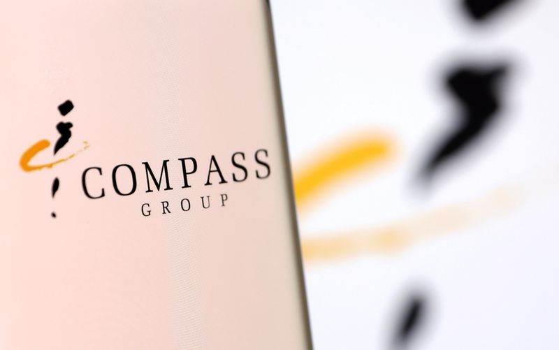 &copy; Reuters. FILE PHOTO: Compass Group's logo is pictured on a smartphone in this illustration taken, December 4, 2021. REUTERS/Dado Ruvic/Illustration