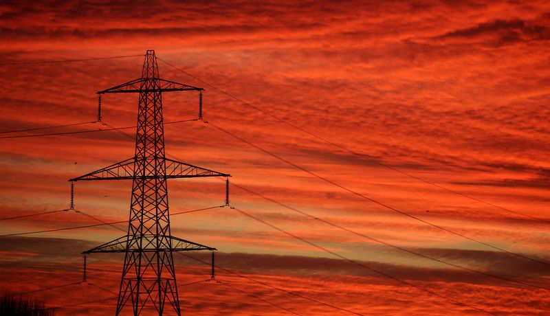 &copy; Reuters. FILE PHOTO: The sun rises behind an electricity pylon in Manchester, Britain, January 18, 2022. REUTERS/Phil Noble