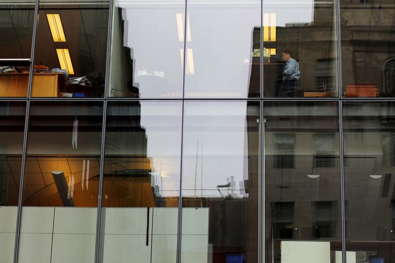 &copy; Reuters. FILE PHOTO: A worker sits at his desk in an office building in Washington, U.S., August 3, 2018. REUTERS/Brian Snyder/File Photo