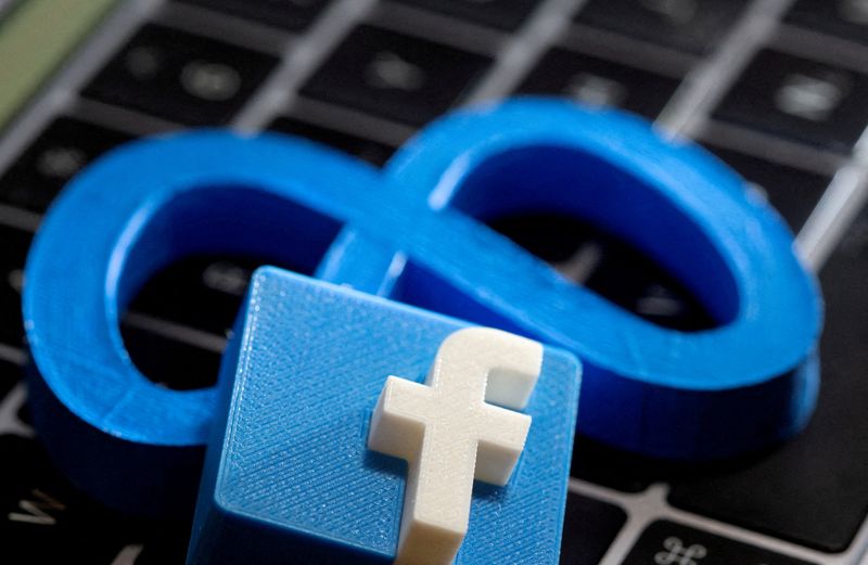 &copy; Reuters. FILE PHOTO: The logo of Facebook parent Meta is beneath a 3D-printed logo of Facebook on a laptop keyboard in this illustration taken on November 2, 2021. REUTERS/Dado Ruvic/Illustration/File Photo