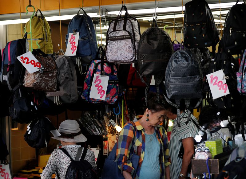 &copy; Reuters. FILE PHOTO: Shoppers look around goods at a shop in Tokyo, Japan October 1, 2019. REUTERS/Kim Kyung-Hoon