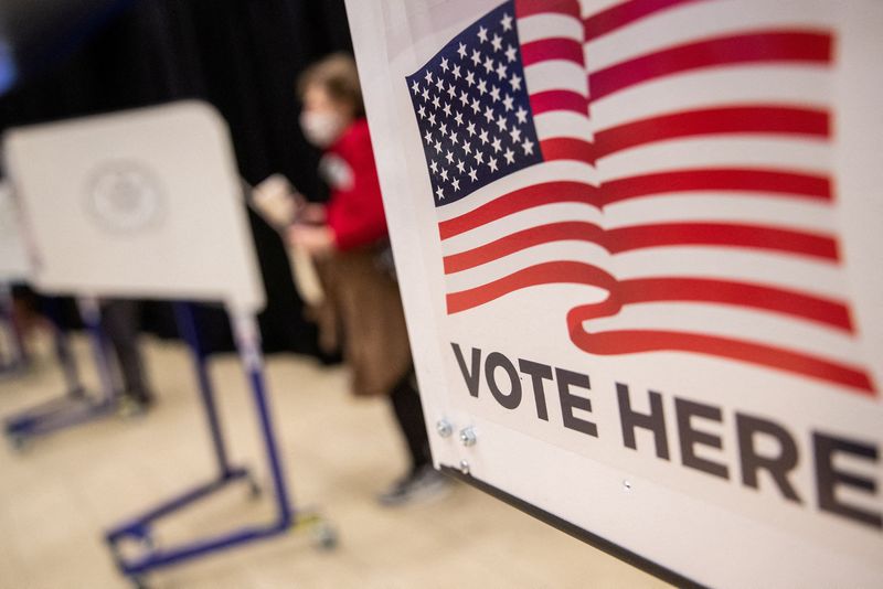 &copy; Reuters. FILE PHOTO: An American flag sign is seen on a voting booth at Madison Square Garden in Manhattan, New York, U.S. October 24, 2020.  REUTERS/Jeenah Moon/File Photo