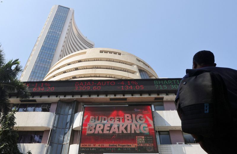 &copy; Reuters. FILE PHOTO: A man looks at a screen displaying budget news, on a facade of the Bombay Stock Exchange (BSE) building in Mumbai, India, February 1, 2022. REUTERS/Francis Mascarenhas