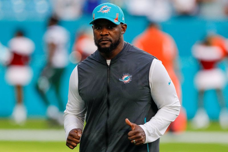 &copy; Reuters. FILE PHOTO: Dec 19, 2021; Miami Gardens, Florida, USA; Miami Dolphins head coach Brian Flores runs off the field after winning the game against the New York Jets at Hard Rock Stadium. Mandatory Credit: Sam Navarro-USA TODAY Sports/File Photo