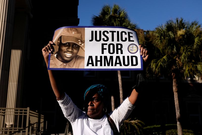 &copy; Reuters. FILE PHOTO: A woman holds a sign outside the Glynn County Courthouse after the jury reached a guilty verdict in the trial of William "Roddie" Bryan, Travis McMichael and Gregory McMichael, charged with the February 2020 death of 25-year-old Ahmaud Arbery,