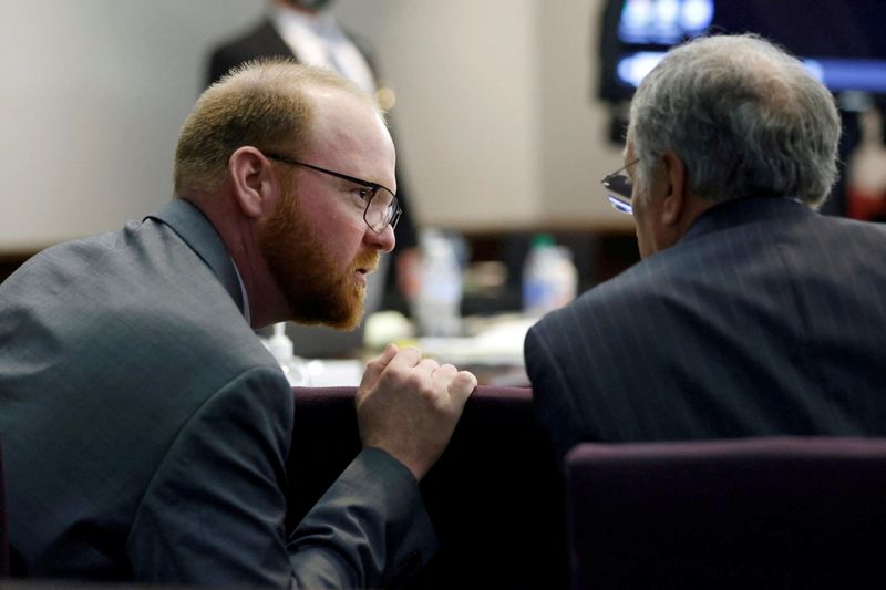 &copy; Reuters. FILE PHOTO: Travis McMichael speaks with his defense attorney Robert Rubin during the trial of William "Roddie" Bryan, Travis McMichael and Gregory McMichael, who are charged with the February 2020 death of 25-year-old Ahmaud Arbery, at the Gwynn County S