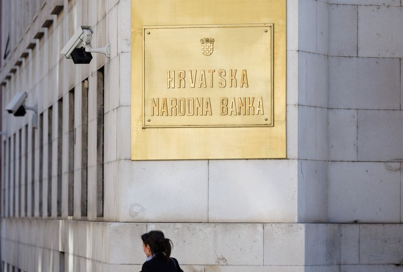 &copy; Reuters. A woman passes a sign on the building of Croatian National Bank in downtown of Zagreb, Croatia, February 7, 2022. REUTERS/Antonio Bronic