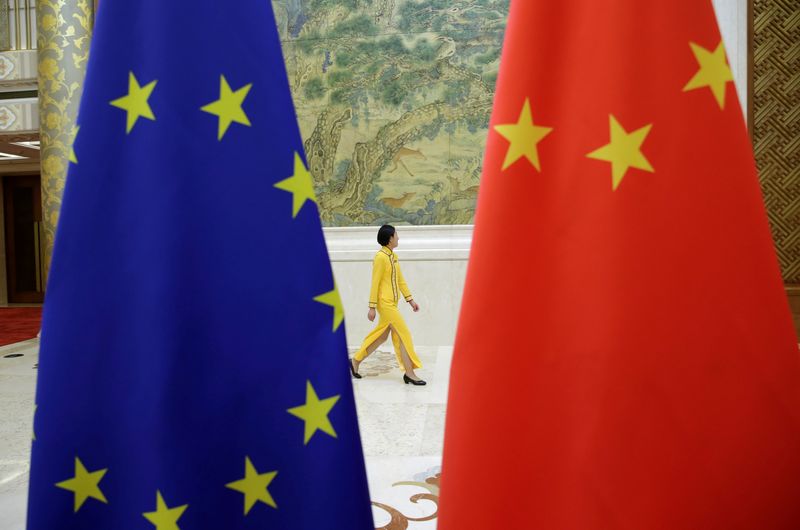 &copy; Reuters. An attendant walks past EU and China flags ahead of the EU-China High-level Economic Dialogue at Diaoyutai State Guesthouse in Beijing, China June 25, 2018. REUTERS/Jason Lee/File Photo