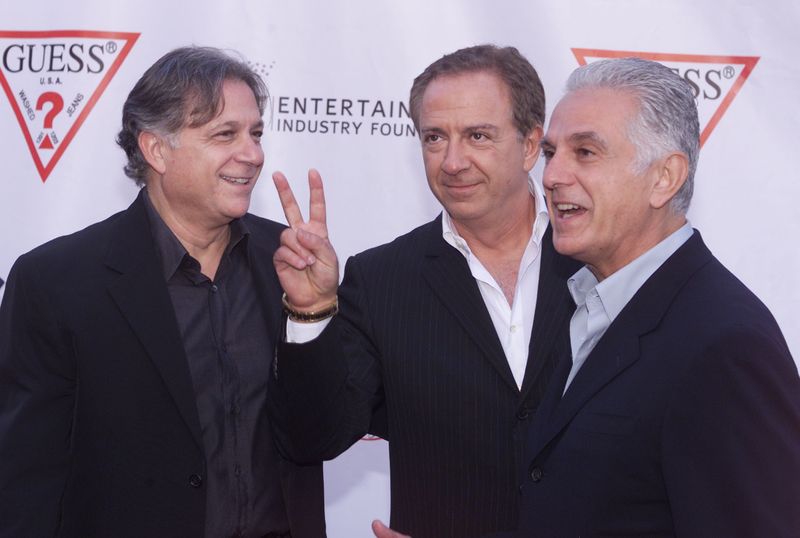 &copy; Reuters. FILE PHOTO: Armand (L) Paul (C) and Maurice Marciano, founders of the GUESS?
clothing line pose as they arrive at their company's 20th anniversary
party in Los Angeles May 9, 2002. The brothers, originally from France,
started the company in Los Angeles t
