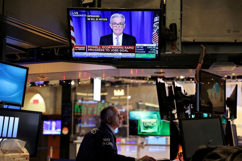 &copy; Reuters. FILE PHOTO: Federal Reserve Chair Jerome Powell is seen delivering remarks on a screen as a trader works on the trading floor at the New York Stock Exchange (NYSE) in Manhattan, New York City, U.S., December 15, 2021. REUTERS/Andrew Kelly