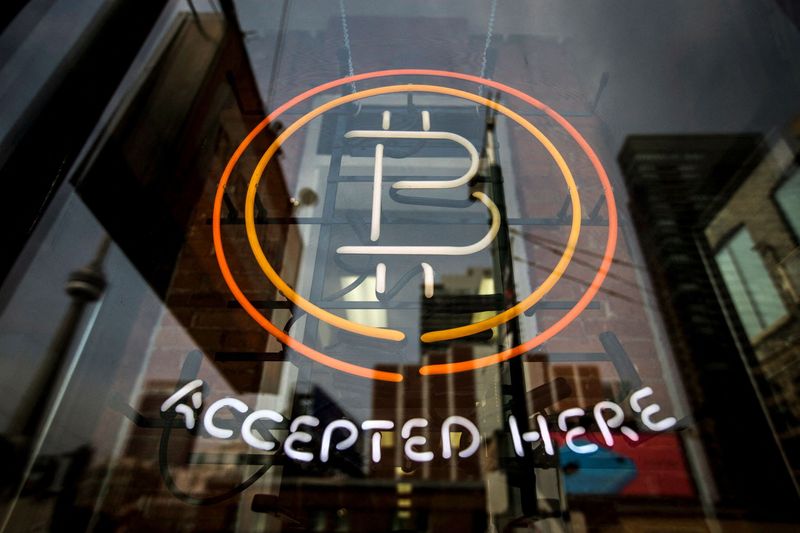 &copy; Reuters. FILE PHOTO: A Bitcoin sign is seen in a window in Toronto, May 8, 2014.   REUTERS/Mark Blinch