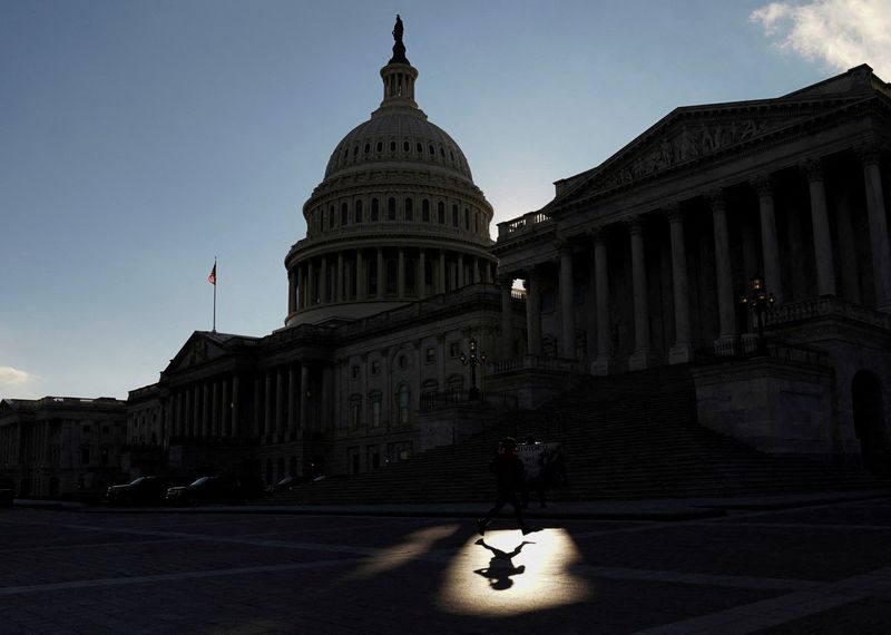 &copy; Reuters. FILE PHOTO: A jogger passes through a beam of sunlight in front of the U.S Capitol in Washington, U.S., January 18, 2022. REUTERS/Kevin Lamarque/File Photo