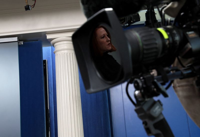 &copy; Reuters. White House Press Secretary Jen Psaki’s reflection is seen on a TV camera lens as she holds a press briefing at the White House in Washington, U.S., February 8, 2022. REUTERS/Leah Millis