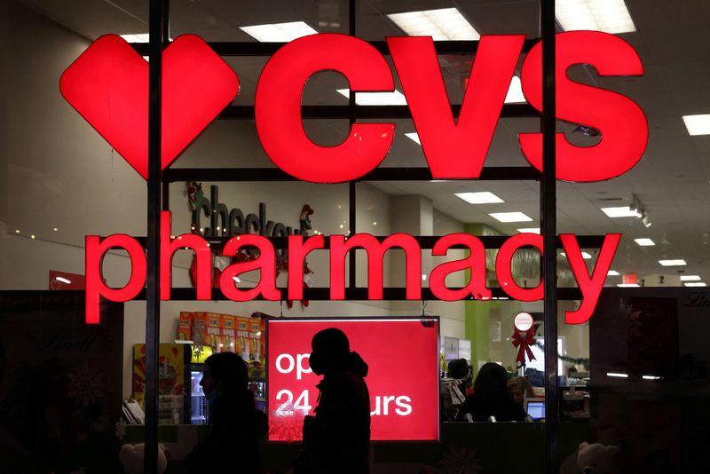 &copy; Reuters. FILE PHOTO: People walk by a CVS pharmacy store in Manhattan, New York City, New York, U.S., November 17, 2021. REUTERS/Andrew Kelly/File Photo