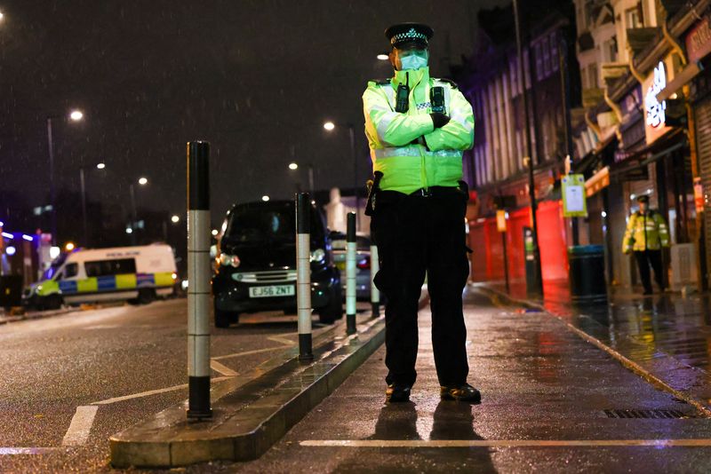 © Reuters. FILE PHOTO: Police officers stand guard at the scene after a car crash incident outside Edmonton Police Station, in Enfield north London, Britain, November 11, 2020. REUTERS/Henry Nicholls