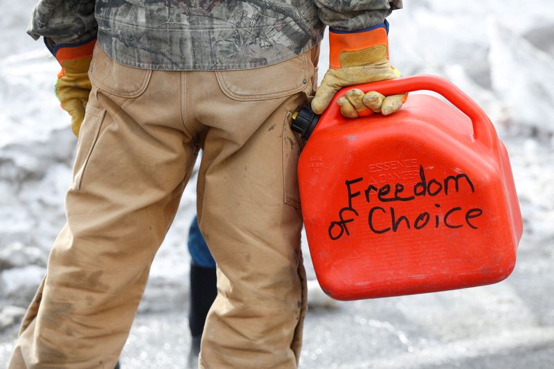 &copy; Reuters. A trucker carries a gas canister with "Freedom of Choice" written on it, as truckers and supporters continue to protest coronavirus disease (COVID-19) vaccine mandates, in Ottawa, Ontario, Canada, February 9, 2022. REUTERS/Lars Hagberg