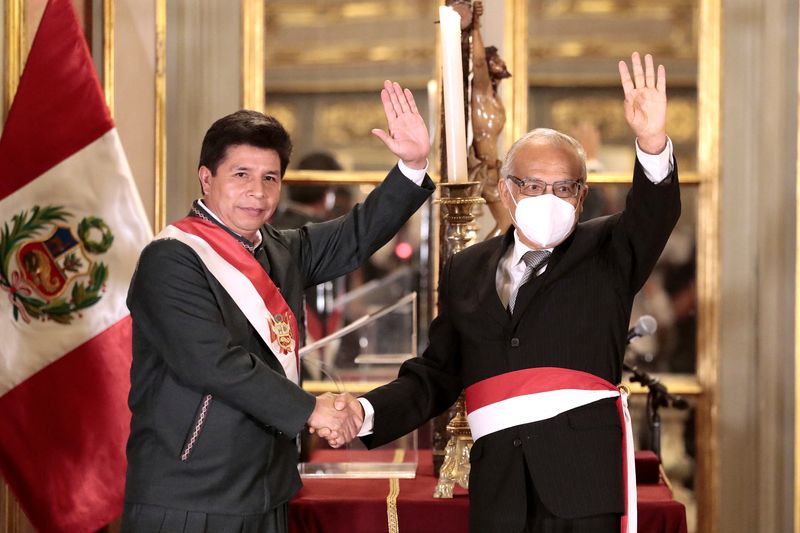 &copy; Reuters. Peru's President Pedro Castillo and Anibal Torres wave after Torres was sworn in as Peru's new prime minister during the presentation of Castillo's fourth cabinet, which still needs to be confirmed by the opposition-controlled Congress, in Lima, Peru, Feb