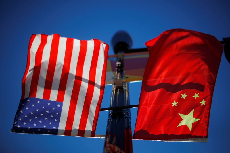 &copy; Reuters. FILE PHOTO: The flags of the United States and China fly from a lamppost in the Chinatown neighborhood of Boston, Massachusetts, U.S., November 1, 2021.   REUTERS/Brian Snyder