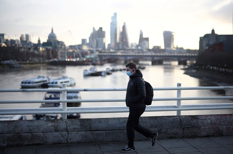 &copy; Reuters. FILE PHOTO: A man wearing a protective face mask walks across Waterloo Bridge, amid the coronavirus disease (COVID-19) outbreak in London, Britain, January 29, 2021. REUTERS/Henry Nicholls/File Photo