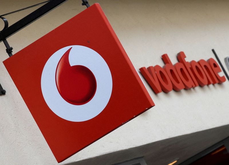 &copy; Reuters. FILE PHOTO: Branding hangs outside a Vodafone shop in Oxford, Britain, May 16, 2017. REUTERS/Toby Melville/File Photo