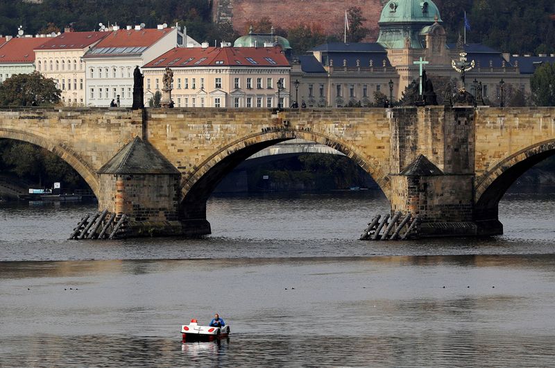 © Reuters. FILE PHOTO: A man rides a pedal boat on the Vltava river in Prague, Czech Republic, October 21, 2020. REUTERS/David W Cerny/File Photo