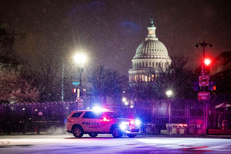 &copy; Reuters. A Metropolitan Police Department car drives through the snow on Capitol Hill in Washington, U.S., January 25, 2021. REUTERS/Al Drago