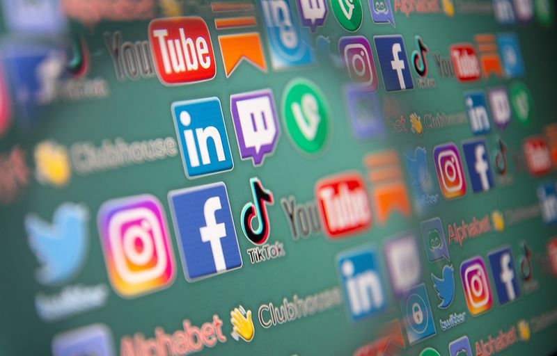 &copy; Reuters. Social media logos are seen through magnifier displayed in this illustration taken, May 25, 2021. Picture taken May 25, 2021. REUTERS/Dado Ruvic/Illustration