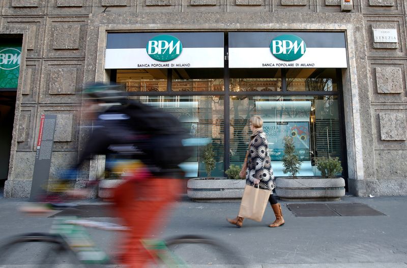 &copy; Reuters. FILE PHOTO: A woman walks in front of the Banca Popolare di Milano (BPM) bank in downtown Milan, Italy, January 29, 2016.   REUTERS/Alessandro Garofalo/File Photo