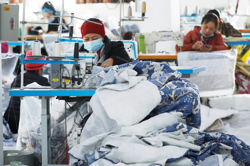 &copy; Reuters. FILE PHOTO: Labourers work at a private garment factory in Hanoi, Vietnam January 8, 2021. REUTERS/Kham