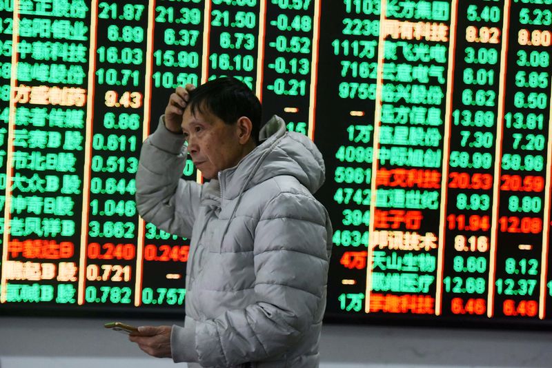 &copy; Reuters. A man gestures in front of an electronic board showing stock information at a brokerage house in Hangzhou, Zhejiang province, China February 9, 2018. REUTERS/Stringer  ATTENTION EDITORS - THIS IMAGE WAS PROVIDED BY A THIRD PARTY. CHINA OUT.