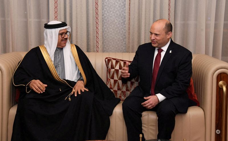 © Reuters. FILE PHOTO: Israeli Prime Minister Naftali Bennett speaks with Bahrain's Foreign Minister Abdullatif Al-Zayani after arriving at Manama International Airport in Manama, Bahrain, February 14, 2022. Haim Zach/Government Press Office (GPO)/via REUTERS/File Photo 