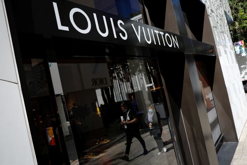 &copy; Reuters. FILE PHOTO: People walk past the Louis Vuitton store at Miami Design District, in Miami, Florida, U.S. November 30, 2021. REUTERS/Marco Bello