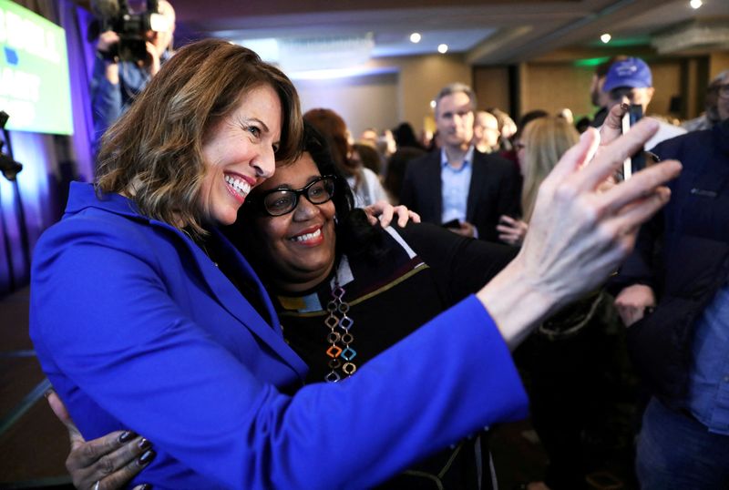 &copy; Reuters. FILE PHOTO: Democratic congressional candidate Cindy Axne (left) takes a photo with West Des Moines City Councilwoman Renee Hardman while appearing at her midterm election night party in Des Moines, Iowa, U.S. November 6, 2018. REUTERS/Scott Morgan/File P