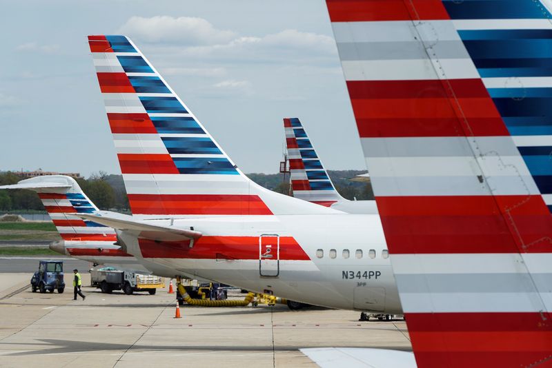 &copy; Reuters. FILE PHOTO: A member of a ground crew walks past American Airlines planes parked at the gate during the coronavirus disease (COVID-19) outbreak at Ronald Reagan National Airport in Washington, U.S., April 5, 2020.      REUTERS/Joshua Roberts/File Photo