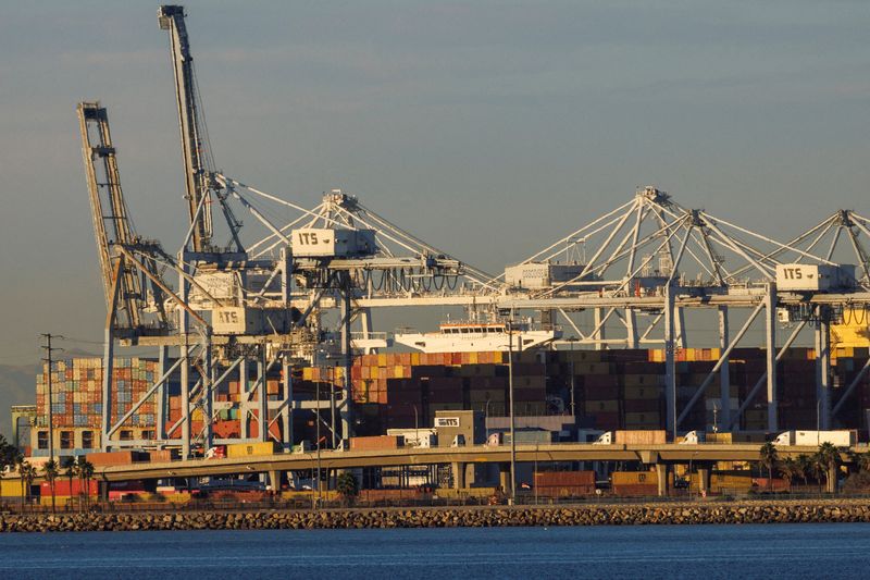 &copy; Reuters. FILE PHOTO: Container trucks , ships and cranes are shown at the Port of Long Beach as supply chain problem continue from Long Beach, California, U.S. November 22, 2021. REUTERS/Mike Blake/File Photo/File Photo