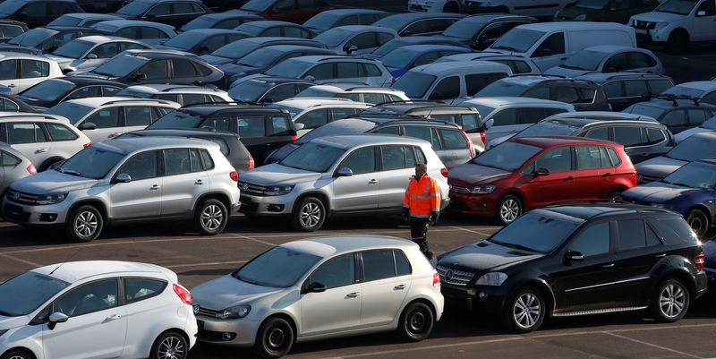 &copy; Reuters. FILE PHOTO: A worker poses as he walks between second hand cars at the Auto1.com company grounds in Zoerbig, Germany January 28, 2017. Picture taken January 28, 2017.  REUTERS/Fabrizio Bensch