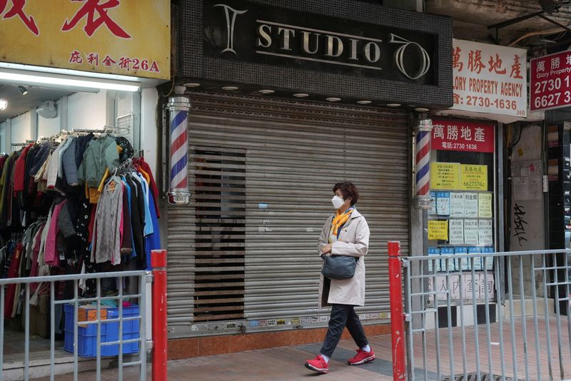 &copy; Reuters. FILE PHOTO: A pedestrian walks past a closed hair salon at a shopping mall, following the coronavirus disease (COVID-19) outbreak, in Hong Kong, China February 10, 2022. REUTERS/Lam Yik