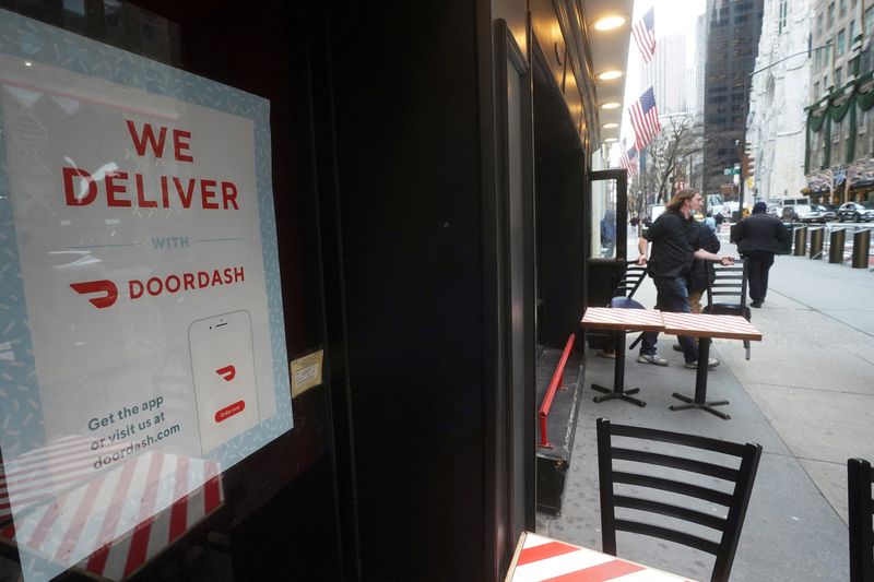 &copy; Reuters. FILE PHOTO: A DoorDash sign is pictured on a restaurant in the Manhattan borough of New York City, New York, U.S., December 9, 2020. REUTERS/Carlo Allegri/File Photo