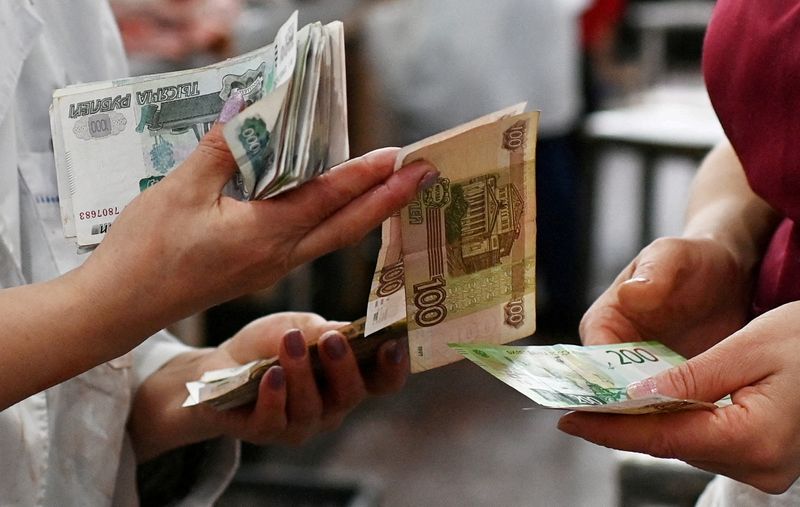 Rouble weakens as Ukraine, Russia-backed rebels trade shelling accusations