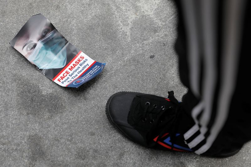 &copy; Reuters. A brochure about face masks is seen on the ground during an anti-mandatory coronavirus disease (COVID-19) vaccine protest held outside New York City Hall in Manhattan, New York City, U.S., August 9, 2021. REUTERS/Andrew Kelly/Files