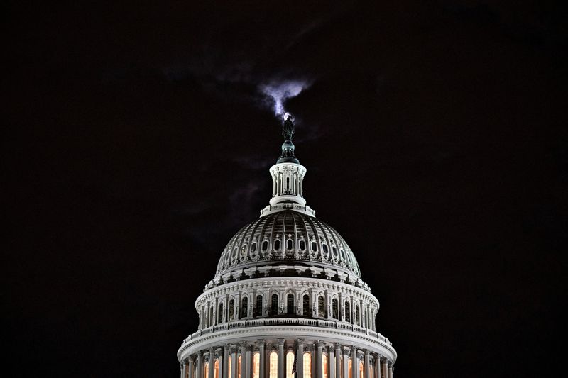 &copy; Reuters. The moon is seen behind the dome of the U.S. Capitol building at night in Washington, DC, U.S., February 16, 2022. REUTERS/Jon Cherry